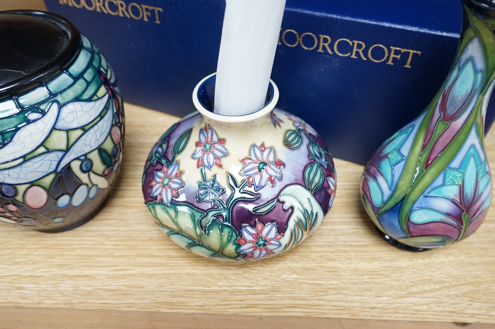 Four Moorcroft vases: Favrile Jar, Kerry vase, Cleopatra vase and a Borage vase. All boxed, tallest 17cm